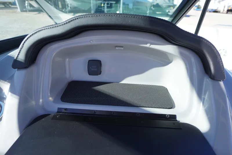 Slide: The Image of Interior view of 2026 Chaparral 23 SSi boat dashboard with storage compartment. - 25