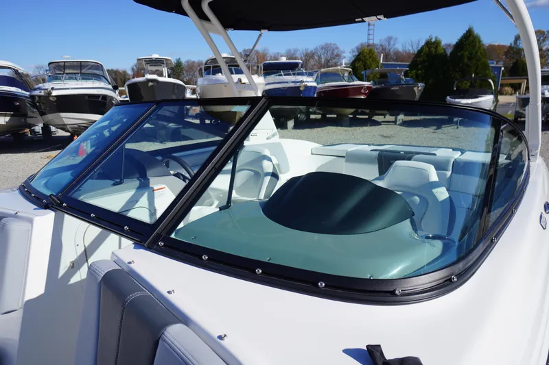 Slide: The Image of 2026 Chaparral 23 SSi boat with sleek windshield and modern interior design. - 29