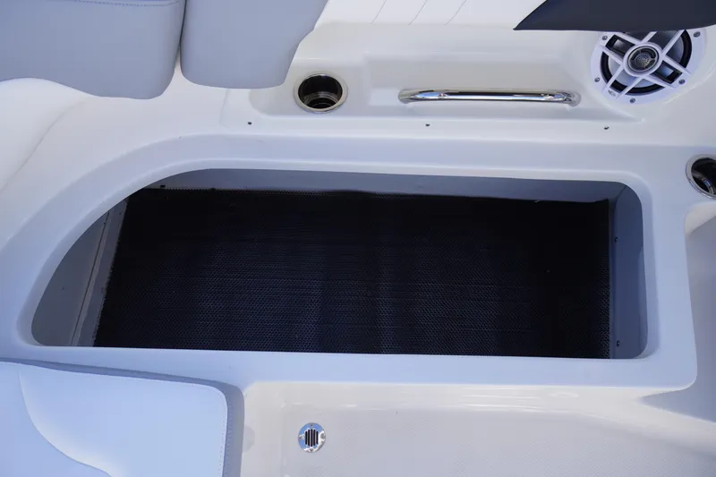 Slide: The Image of 2026 Chaparral 23 SSi boat storage compartment with speaker and handle. - 43