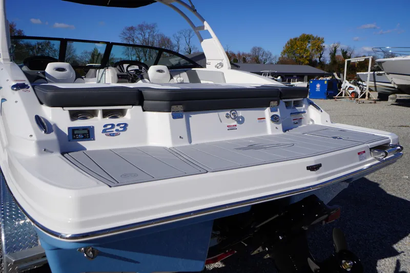 Slide: The Image of 2026 Chaparral 23 SSi boat with sleek design and spacious seating, displayed outdoors. - 58