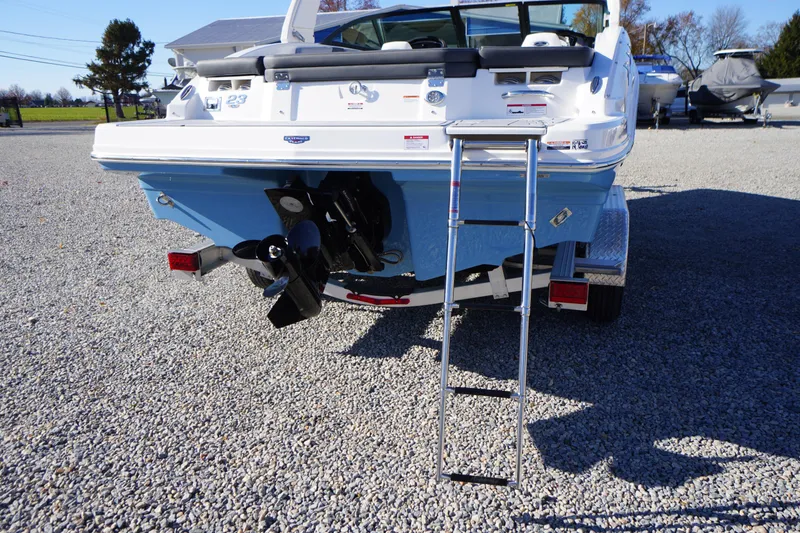 Slide: The Image of 2026 Chaparral 23 SSi boat rear view with ladder on gravel surface. - 63