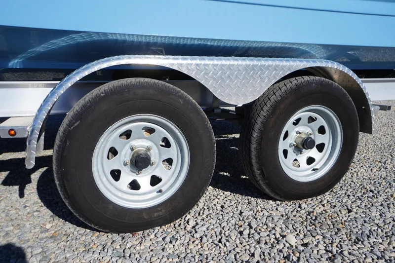 Slide: The Image of Trailer wheels of 2026 Chaparral 23 SSi boat on gravel surface. - 64