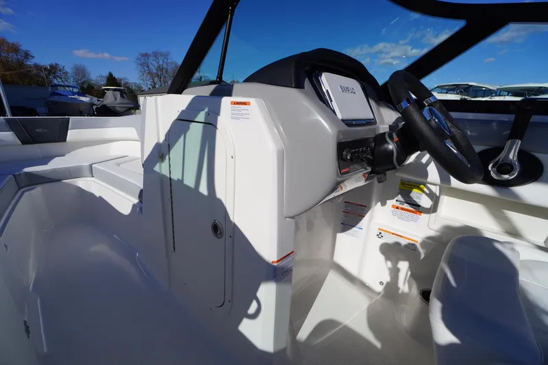 Slide: The Image of 2026 Chaparral 23 SSi boat interior with steering wheel and control panel. - 18