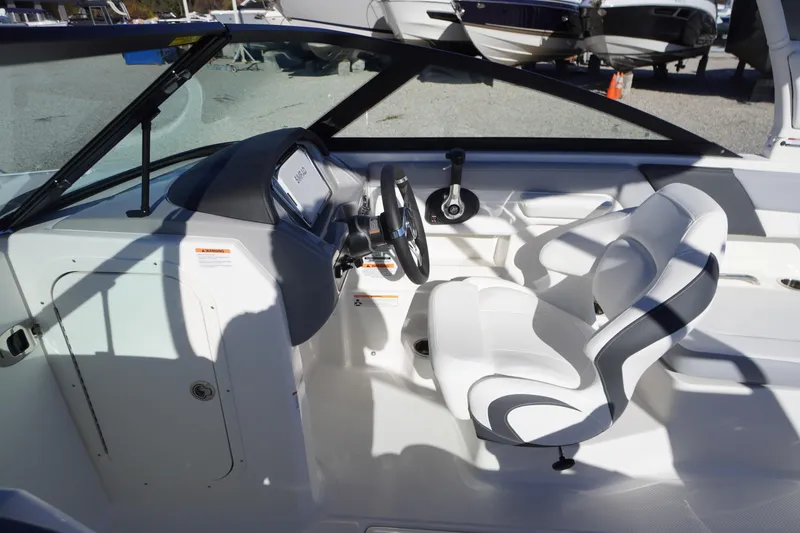 Slide: The Image of Interior of 2026 Chaparral 23 SSi boat with white seating and steering console. - 28
