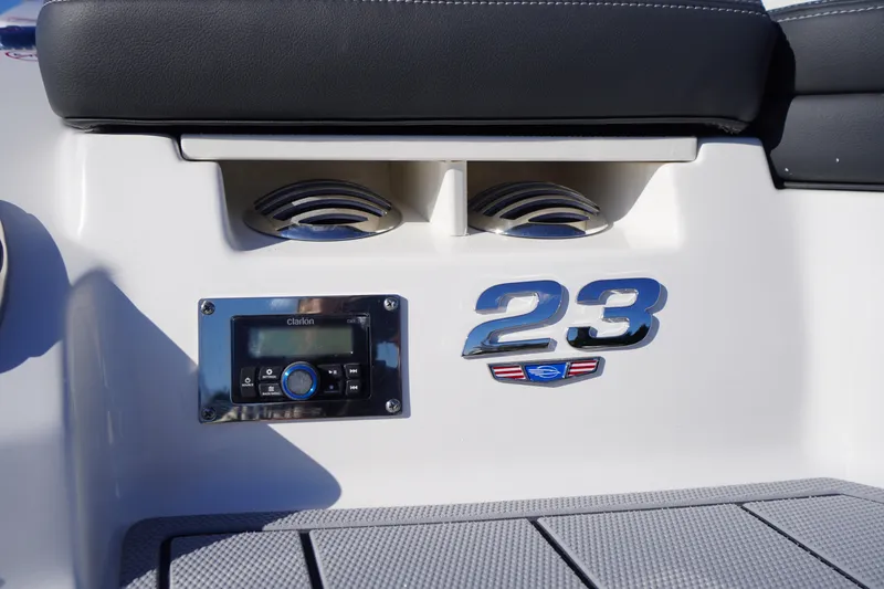 Slide: The Image of 2026 Chaparral 23 SSi boat interior with audio system and model emblem. - 57