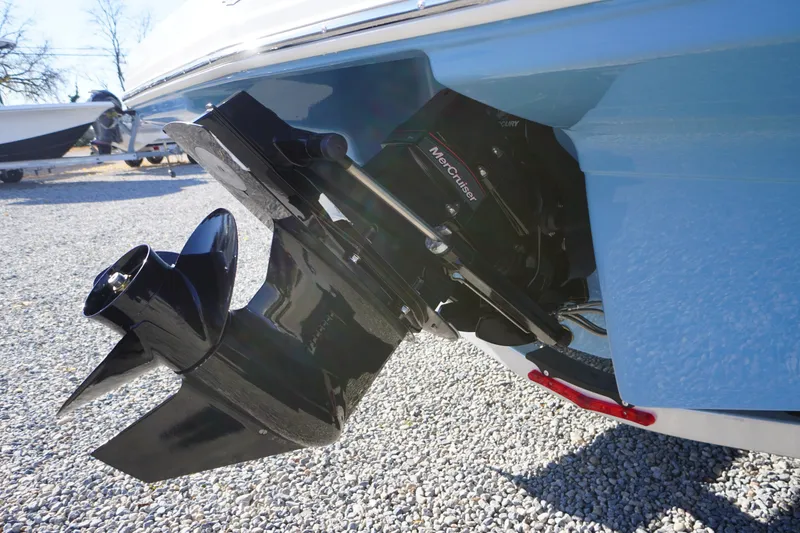 Slide: The Image of 2026 Chaparral 23 SSi boat with MerCruiser outdrive on gravel surface. - 62