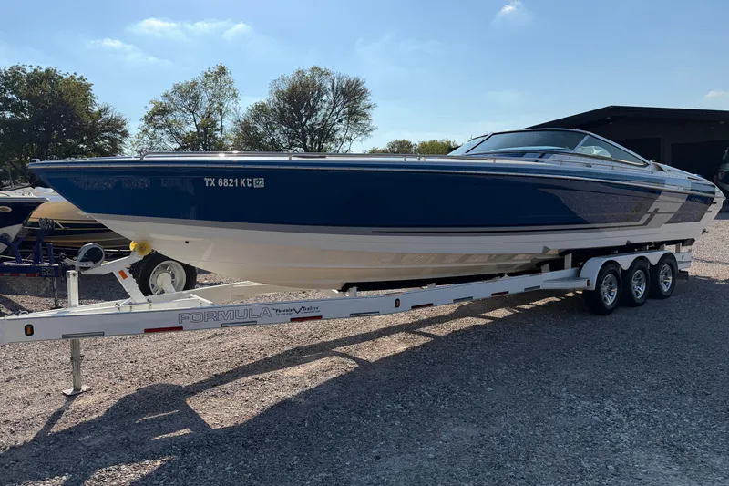 Slide: The Image of Storage compartment in a 2019 Formula 353 FASTech boat with colorful towel and red life jacket. - 27