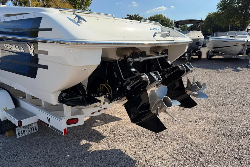 Slide: The Image of 2019 Formula 353 FASTech boat with sleek blue and white design on trailer. - 8