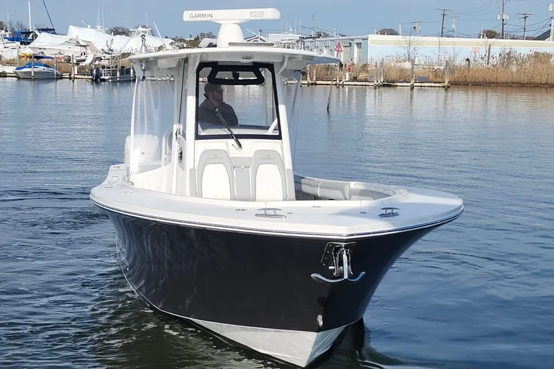 Slide: The Image of 2022 Regulator 34 boat on calm water, featuring sleek design and advanced navigation equipment. - 10