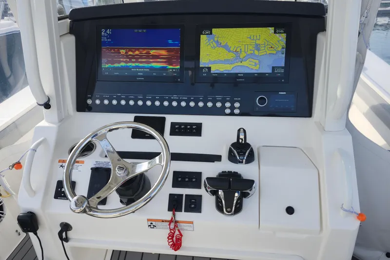 Slide: The Image of 2022 Regulator 34 boat dashboard with dual Garmin displays and steering wheel. - 11