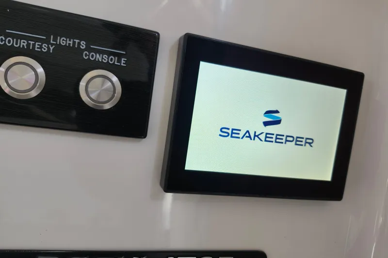 Slide: The Image of Seakeeper display and light controls on 2022 Regulator 34 boat console. - 17