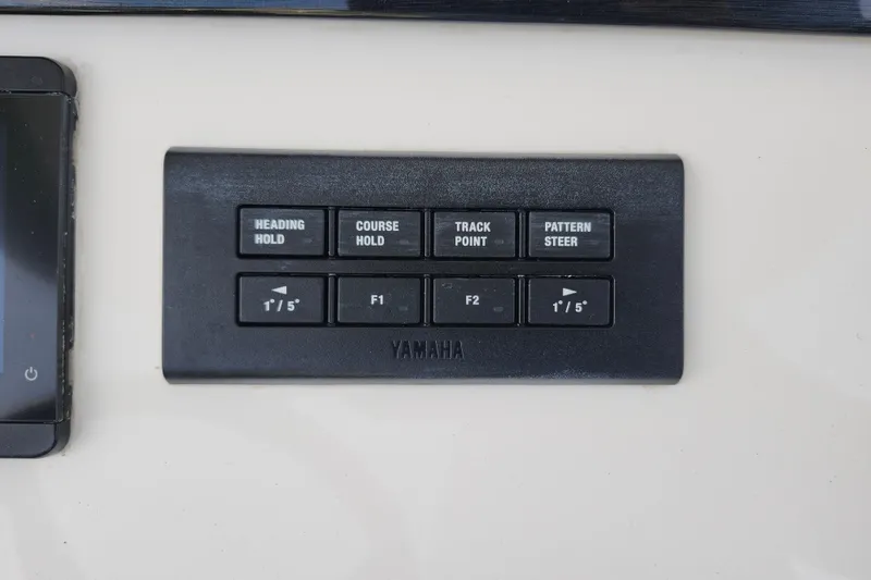 Slide: The Image of Control panel on a 2022 Regulator 34 boat featuring Yamaha navigation buttons. - 19