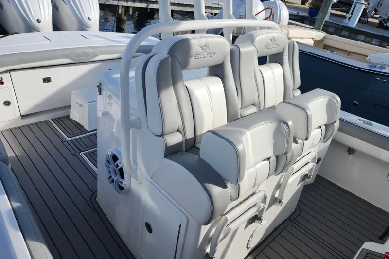 Slide: The Image of 2022 Regulator 34 boat interior with cushioned seating and sleek design. - 22