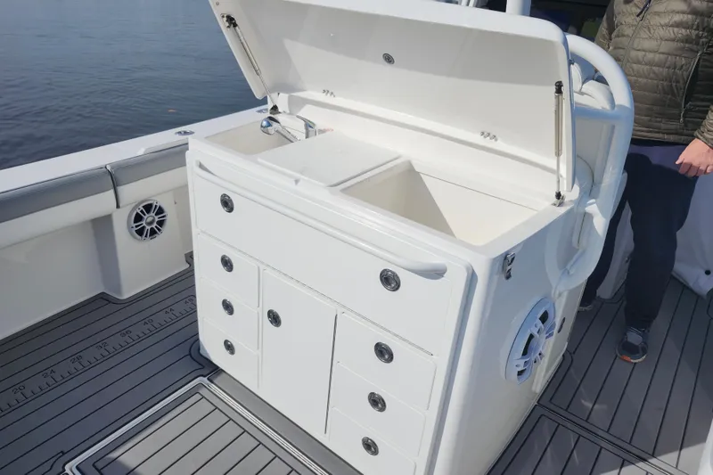 Slide: The Image of 2022 Regulator 34 boat with open storage compartment and drawers on deck. - 24
