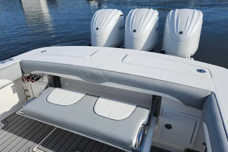 Slide: The Image of 2022 Regulator 34 boat with triple Yamaha engines and sleek seating. - 28