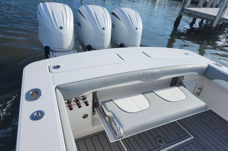 Slide: The Image of 2022 Regulator 34 boat with triple outboard engines, sleek seating, and modern design. - 29