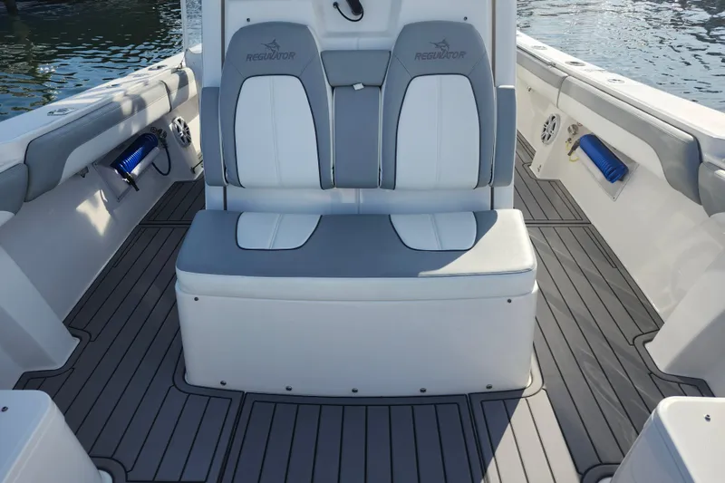 Slide: The Image of 2022 Regulator 34 boat interior with cushioned seating and sleek design. - 33