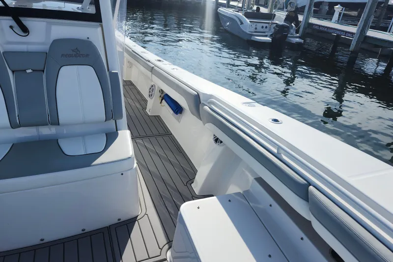 Slide: The Image of 2022 Regulator 34 boat interior with sleek seating and dockside view. - 35