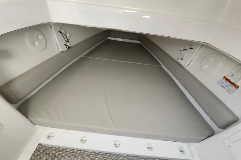 Slide: The Image of 2022 Regulator 34 boat cabin interior with cushioned seating and storage compartments. - 42