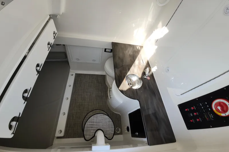 Slide: The Image of 2022 Regulator 34 boat interior with sink, toilet, and control panel. - 43