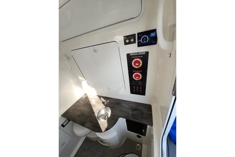 Slide: The Image of 2022 Regulator 34 boat interior with control panel and sink. - 44