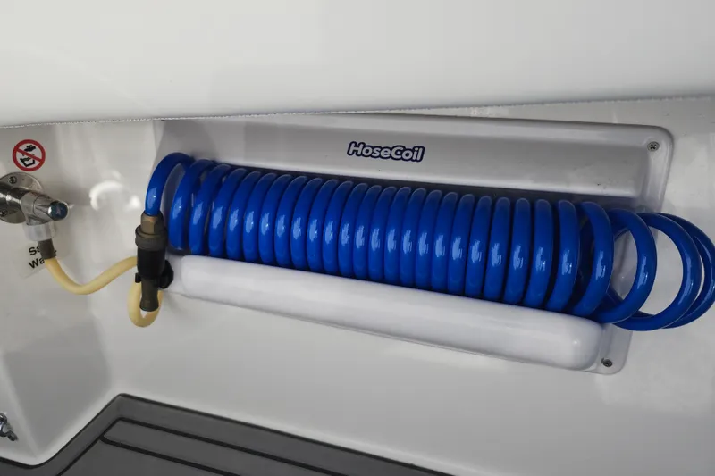 Slide: The Image of Coiled blue hose on 2022 Regulator 34 boat, mounted on white panel. - 45