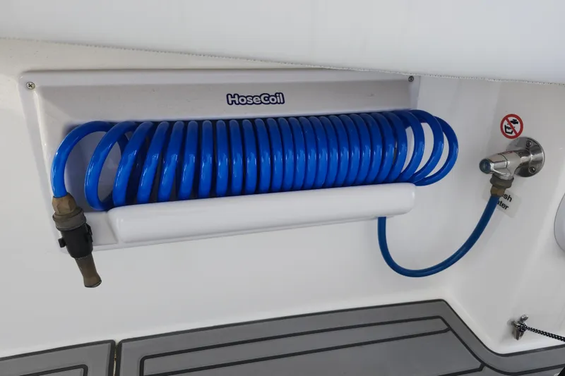 Slide: The Image of Blue coiled hose on 2022 Regulator 34 boat, mounted on white panel. - 46
