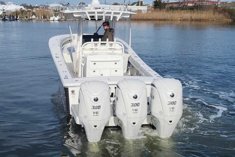 Slide: The Image of 2022 Regulator 34 boat with triple Yamaha 300 V6 engines on calm water. - 5