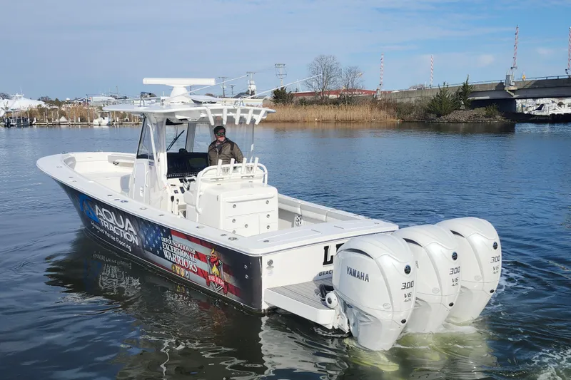Slide: The Image of 2022 Regulator 34 boat with triple Yamaha 300 engines on a calm waterway. - 6