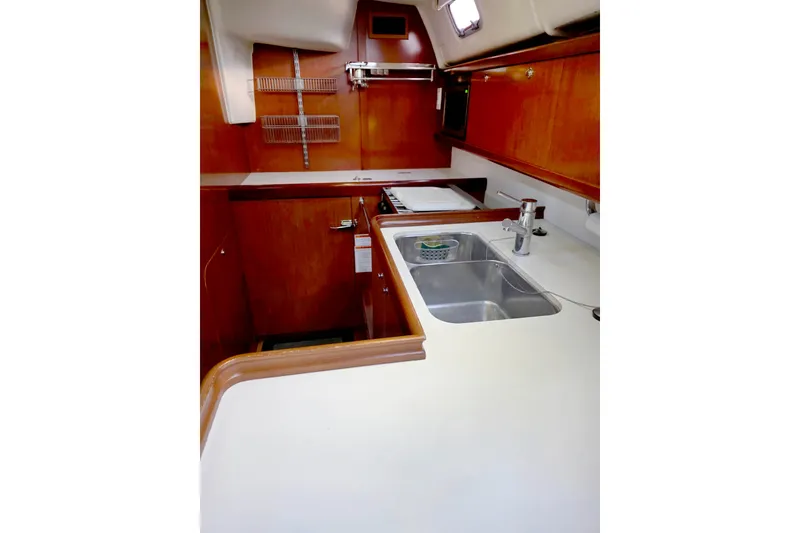 Slide: The Image of Interior of 2011 Beneteau 40 yacht kitchen with wooden cabinetry and dual sink. - 11