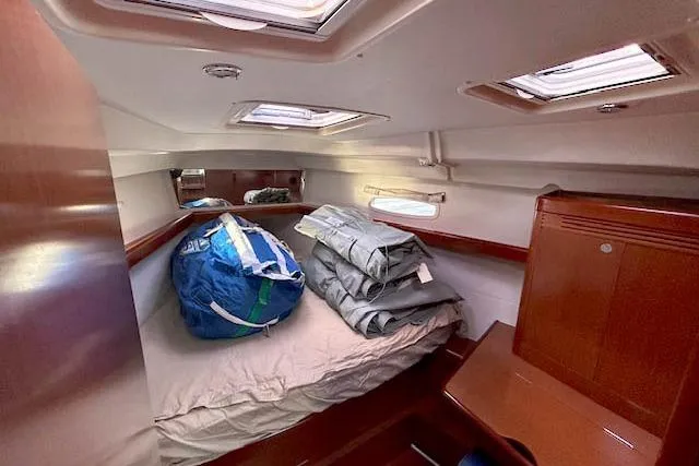 Slide: The Image of 2011 Beneteau Oceanis 40 cabin interior with bed and storage bags. - 13