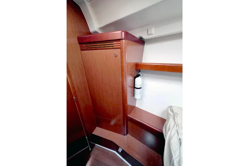Slide: The Image of Interior of 2011 Beneteau 40 yacht with wooden cabinetry and fire extinguisher. - 14