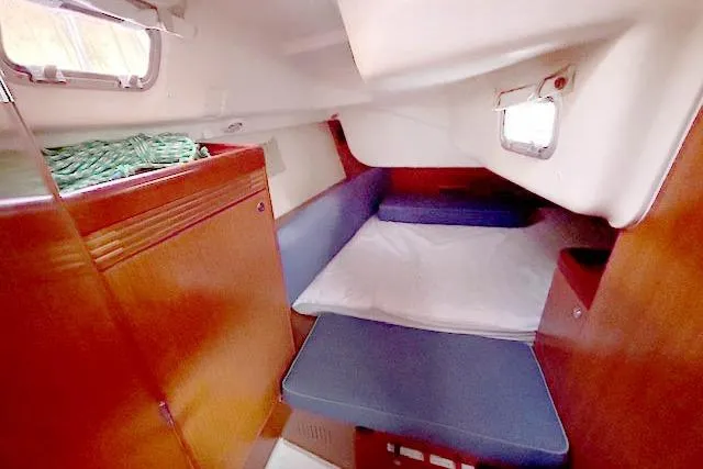 Slide: The Image of 2011 Beneteau Oceanis 40 cabin interior with wooden finish and cozy sleeping area. - 15