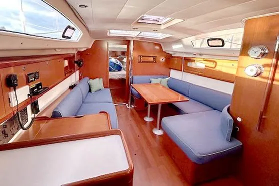 Slide: The Image of Interior of 2011 Beneteau Oceanis 40 sailboat with cozy seating and wooden finishes. - 5