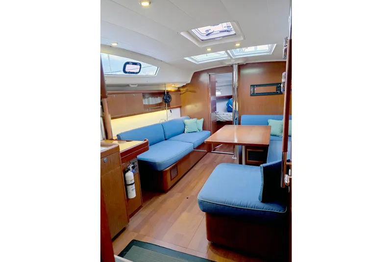 Slide: The Image of Interior of 2011 Beneteau 40 sailboat with blue seating and wooden finishes. - 6