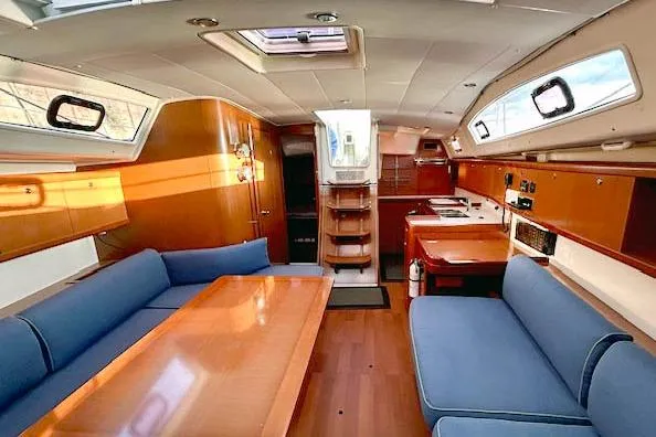Slide: The Image of Interior of 2011 Beneteau Oceanis 40 sailboat with wood finish and blue seating. - 7