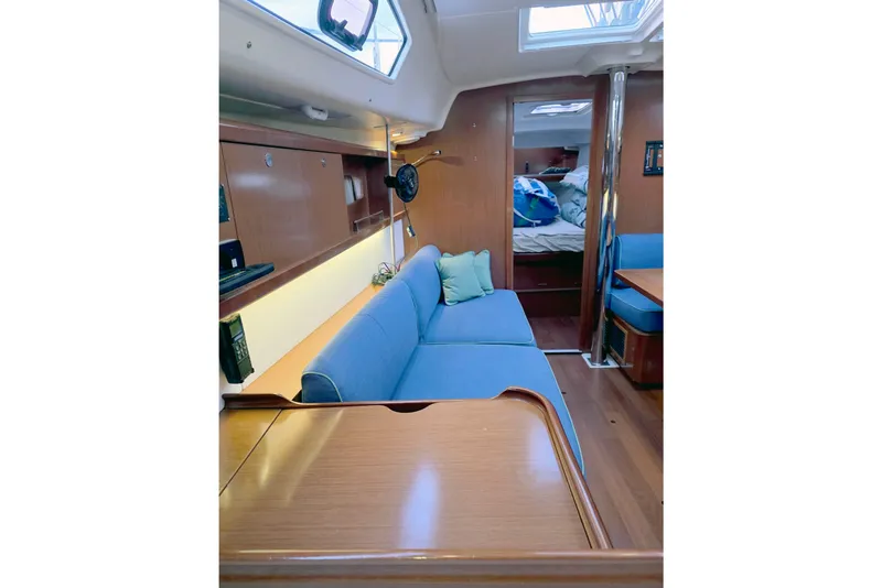 Slide: The Image of Interior of 2011 Beneteau 40 yacht with blue seating and wooden finishes. - 8