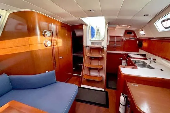 Slide: The Image of Interior of 2011 Beneteau Oceanis 40 yacht with wooden finish and modern amenities. - 9