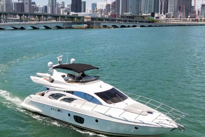 The Image of Luxury 2006 Azimut FLY 55 yacht cruising near city skyline. - 1