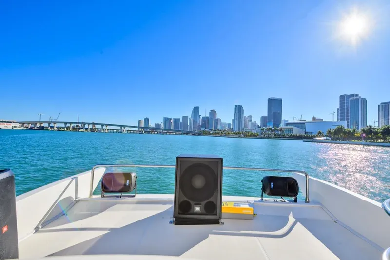 Slide: The Image of Azimut FLY 55 yacht cruising with city skyline and sunny blue sky. - 12
