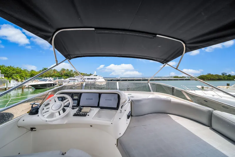 Slide: The Image of 2006 Azimut FLY 55 yacht cockpit with steering wheel and navigation screens, docked at marina. - 9