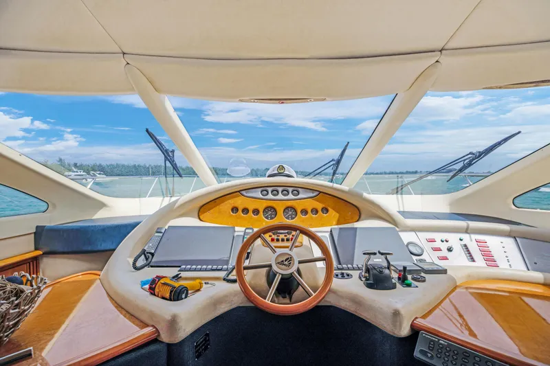 Slide: The Image of Cockpit view of a 2004 Azimut 62 yacht with ocean backdrop. - 12