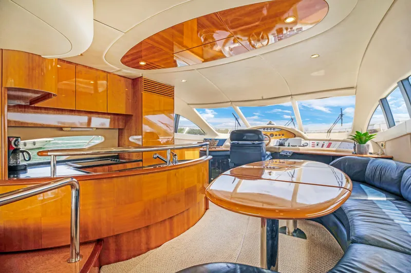 Slide: The Image of Luxurious interior of a 2004 Azimut 62 yacht with polished wood finishes and panoramic windows. - 9