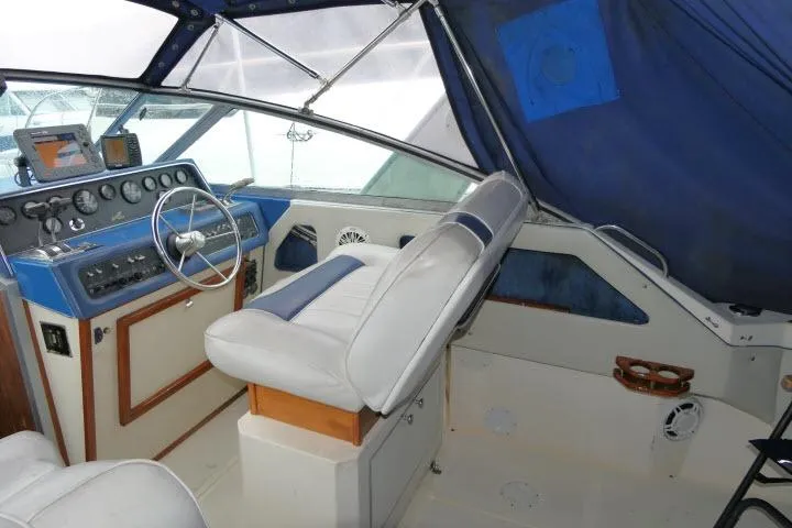Slide: The Image of 1988 Sea Ray 300 Weekender boat interior with steering wheel and navigation equipment. - 14
