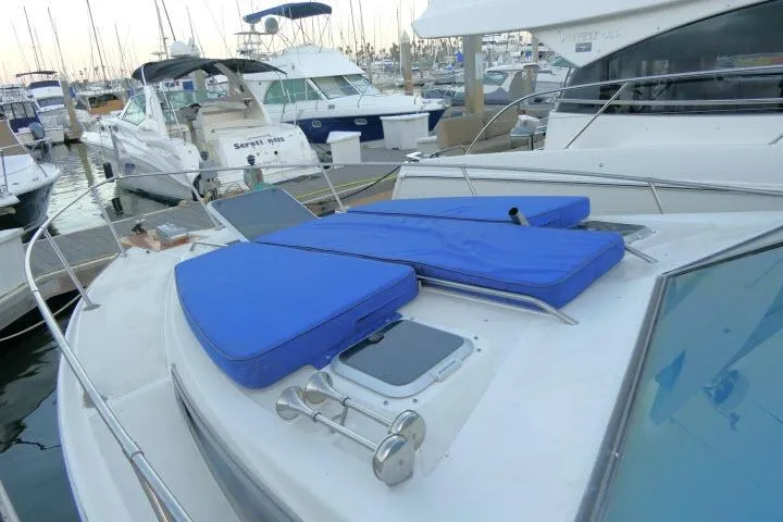 Slide: The Image of 1988 Sea Ray 300 Weekender yacht with blue cushions docked in a marina. - 21