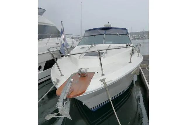 Slide: The Image of 1988 Sea Ray 300 Weekender boat docked in marina, front view. - 25