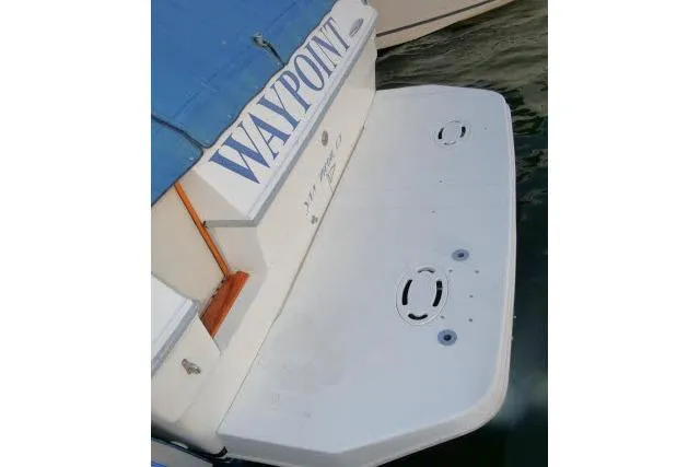 Slide: The Image of 1988 Sea Ray 300 Weekender boat stern with swim platform, docked in water. - 30