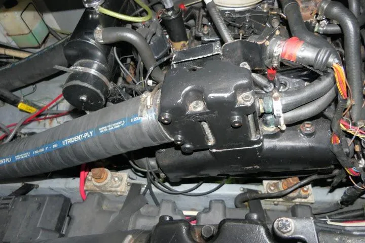 Slide: The Image of Engine components of a 1988 Sea Ray 300 Weekender boat, featuring hoses and wiring. - 31