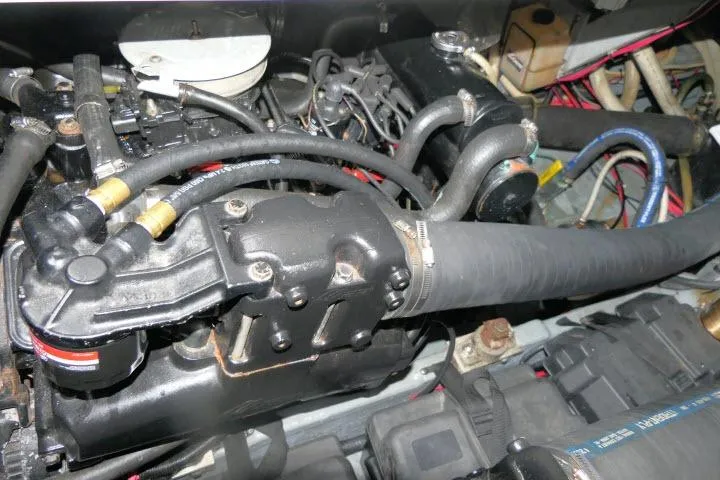 Slide: The Image of Engine compartment of a 1988 Sea Ray 300 Weekender boat, showcasing hoses and components. - 32