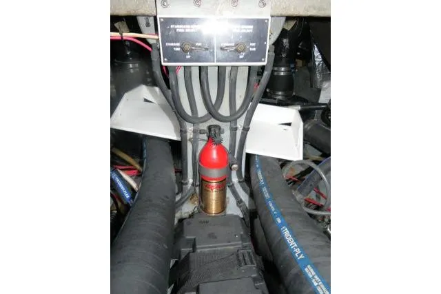 Slide: The Image of Engine compartment of 1988 Sea Ray 300 Weekender with fire extinguisher and wiring. - 33